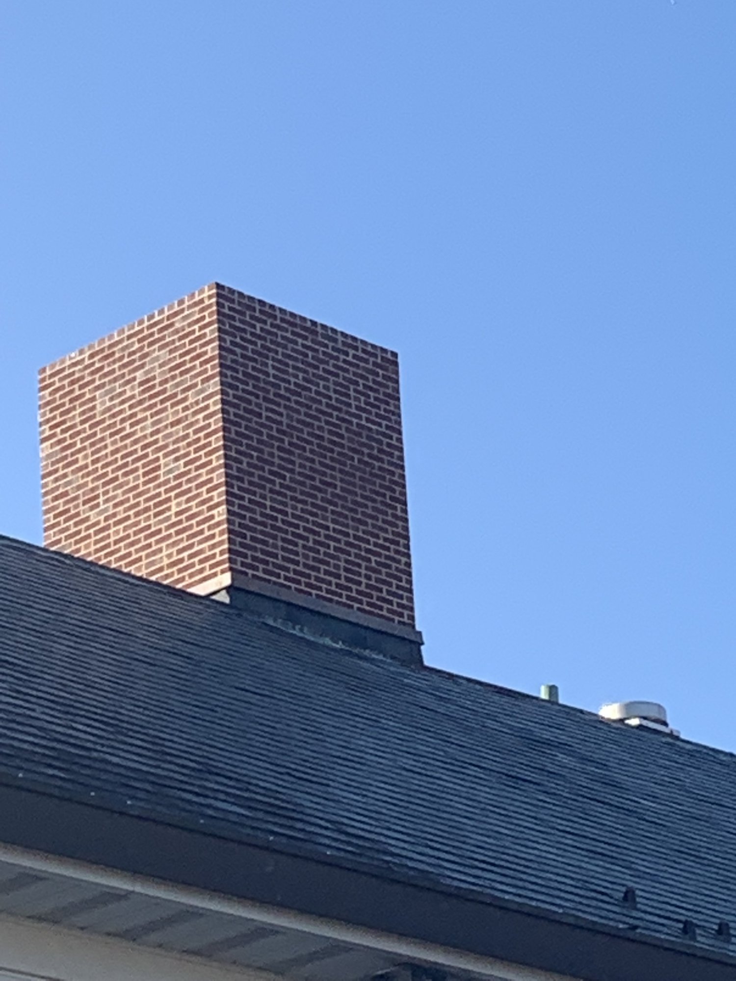 Brick chimney and masonry detail by Olympic Services Inc.