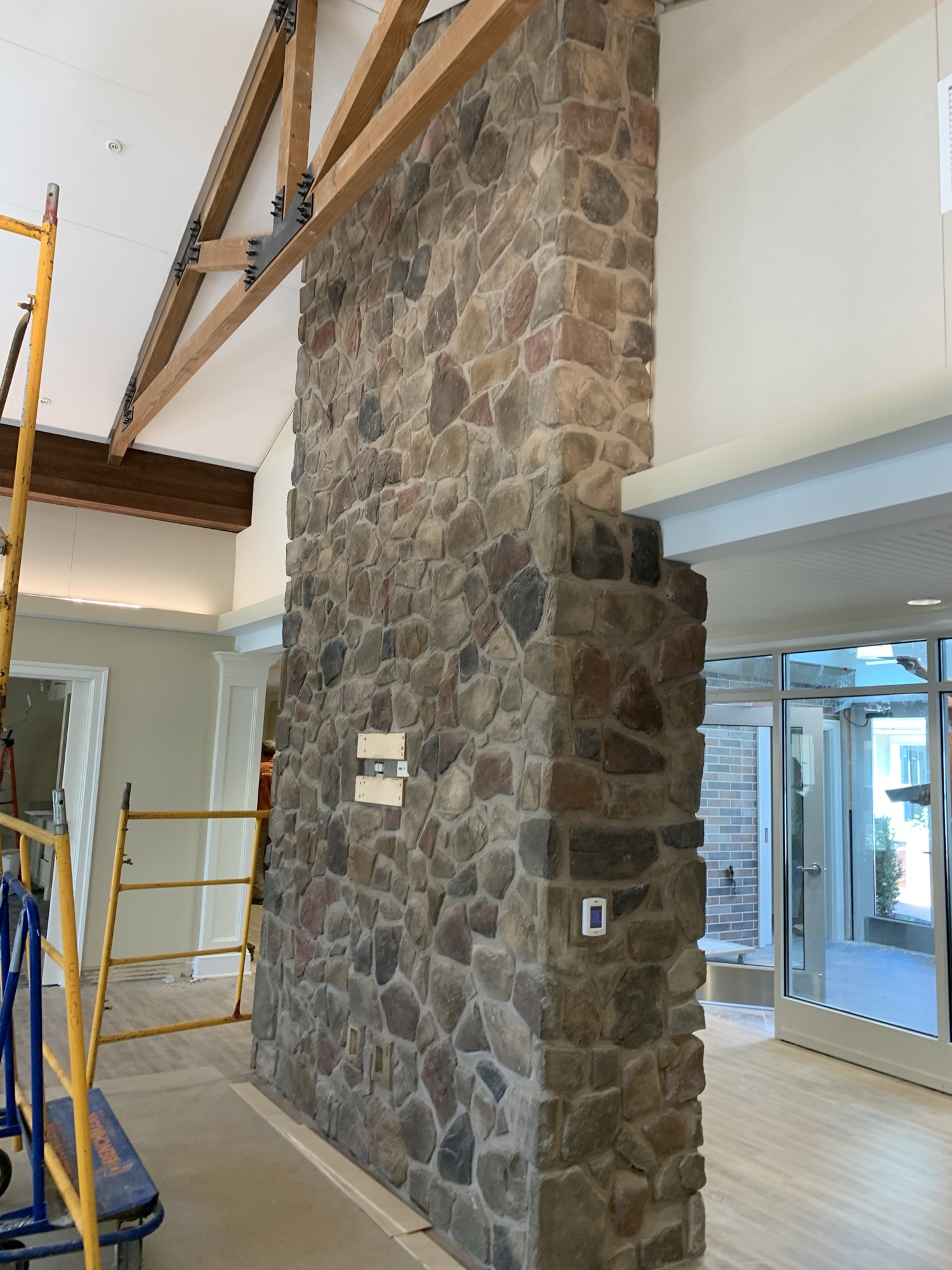 Interior field stone masonry feature completed by Olympic Services Inc.