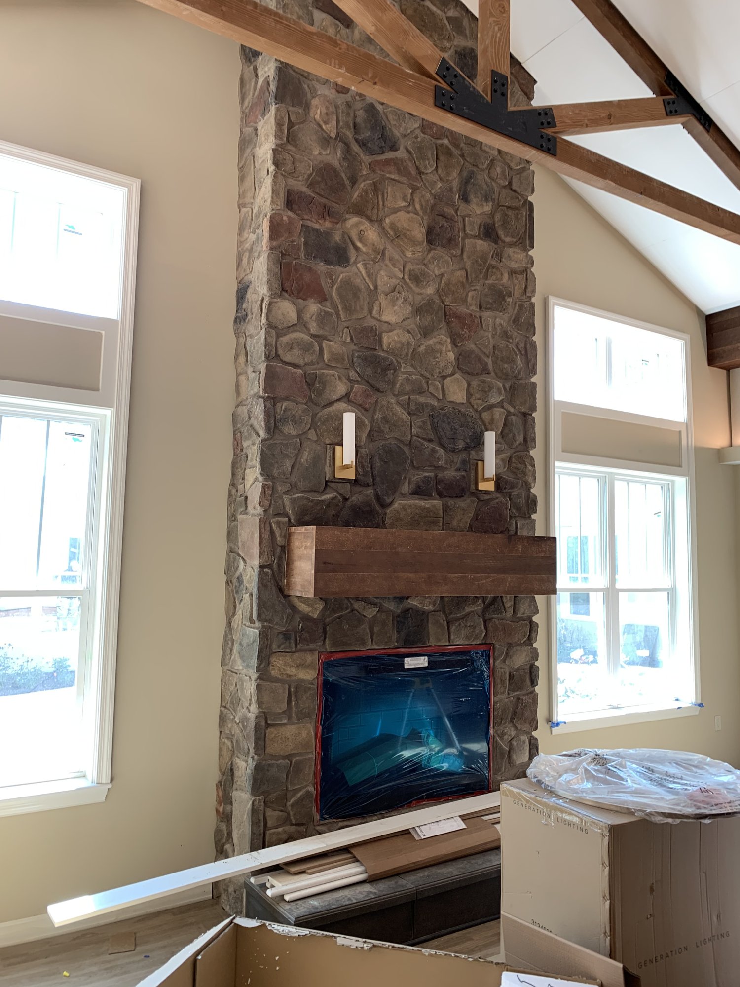 Thin-set stone veneer fireplace installation by Olympic Services Inc.